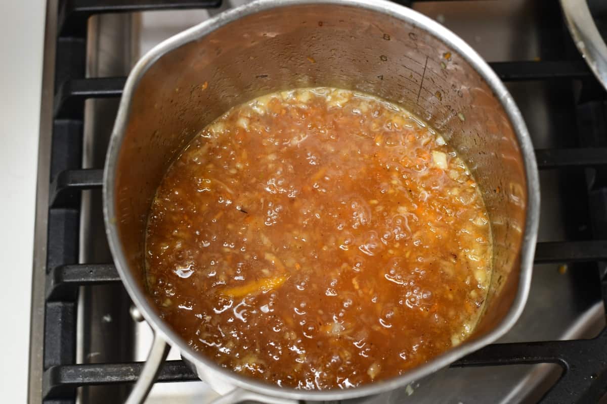 Sauce simmering on a stove.