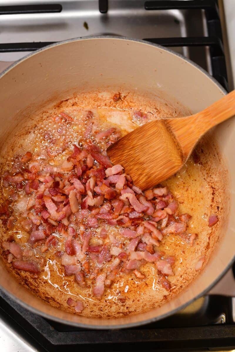 Bacon cooking in a pot on the stove