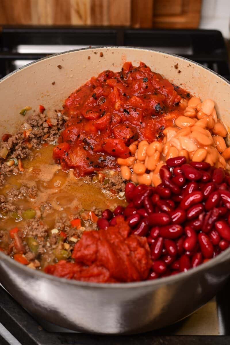 Beans, tomatoes and tomato pastes added to chili.