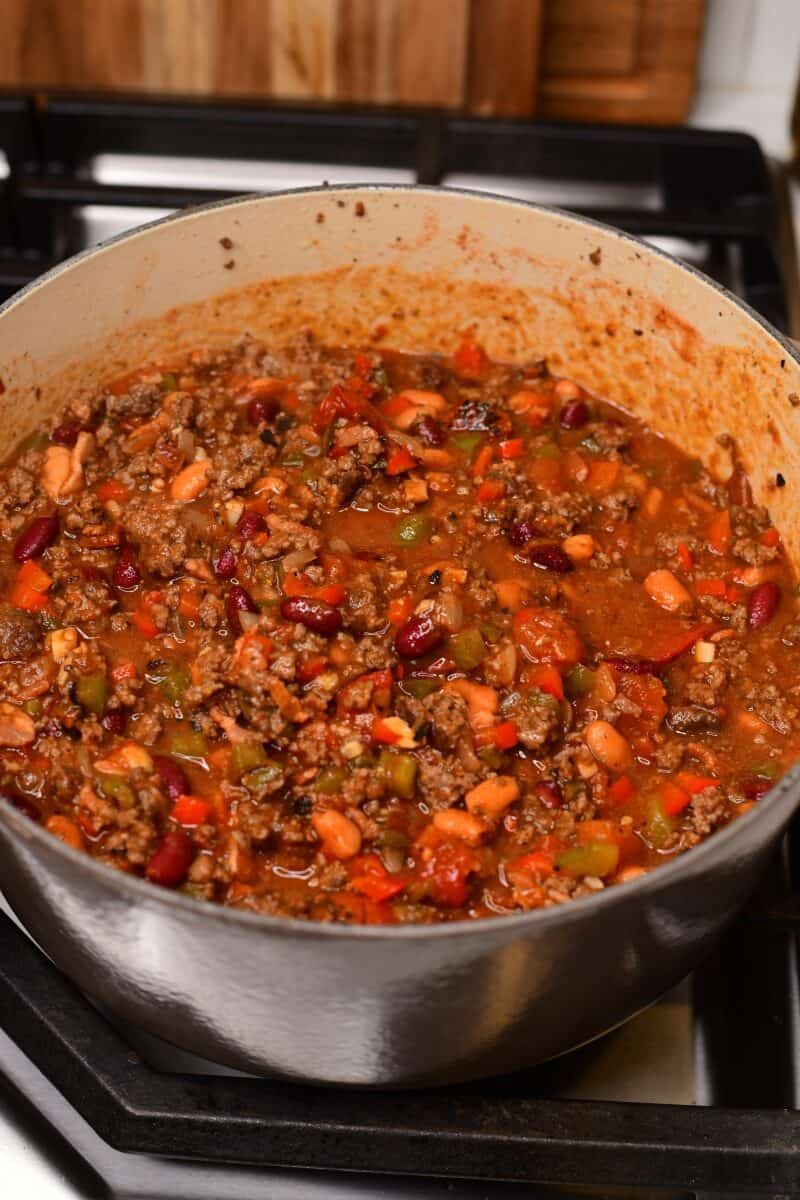 Chili cooking on the stove in a deep pot.