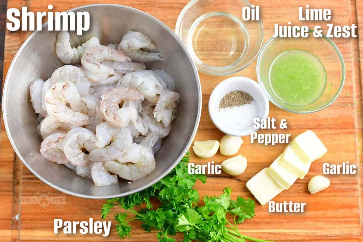 labeled ingredients to make grilled shrimp skewers on a wooden cutting board.
