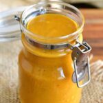 Carolina mustard BBQ sauce in a jar with the lid open.