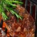 brushing a steak on the grill with rosemary butter brush